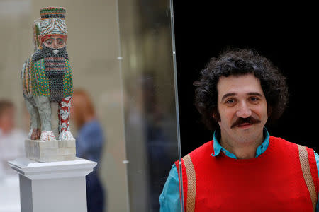 Artist Michael Rakowitz stands beside a scale model of his sculpture 'The Invisible Enemy Should Not Exist' at the National Gallery, after it won the competition to become one of the pieces to be displayed on the fourth plinth in Trafalgar Square, in central London, Britain, March 21, 2017. REUTERS/Stefan Wermuth