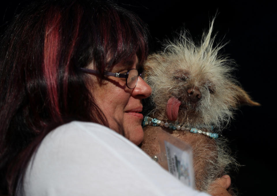 <p>Linda Elmquist of Tucson cuddles her dog Josie, who has an impressively sticky-outy tongue. (Photo by Justin Sullivan/Getty Images)<br></p>