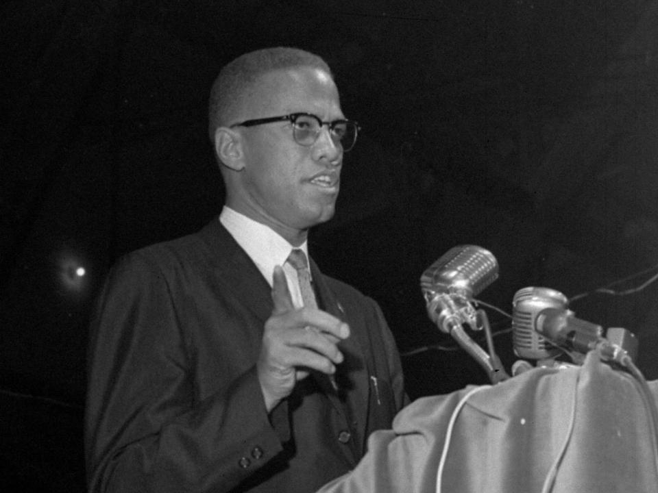 Malcolm X, shown addressing a national convention of Black Muslims, gestures from the rostrum in Chicago, February 26, 1965.