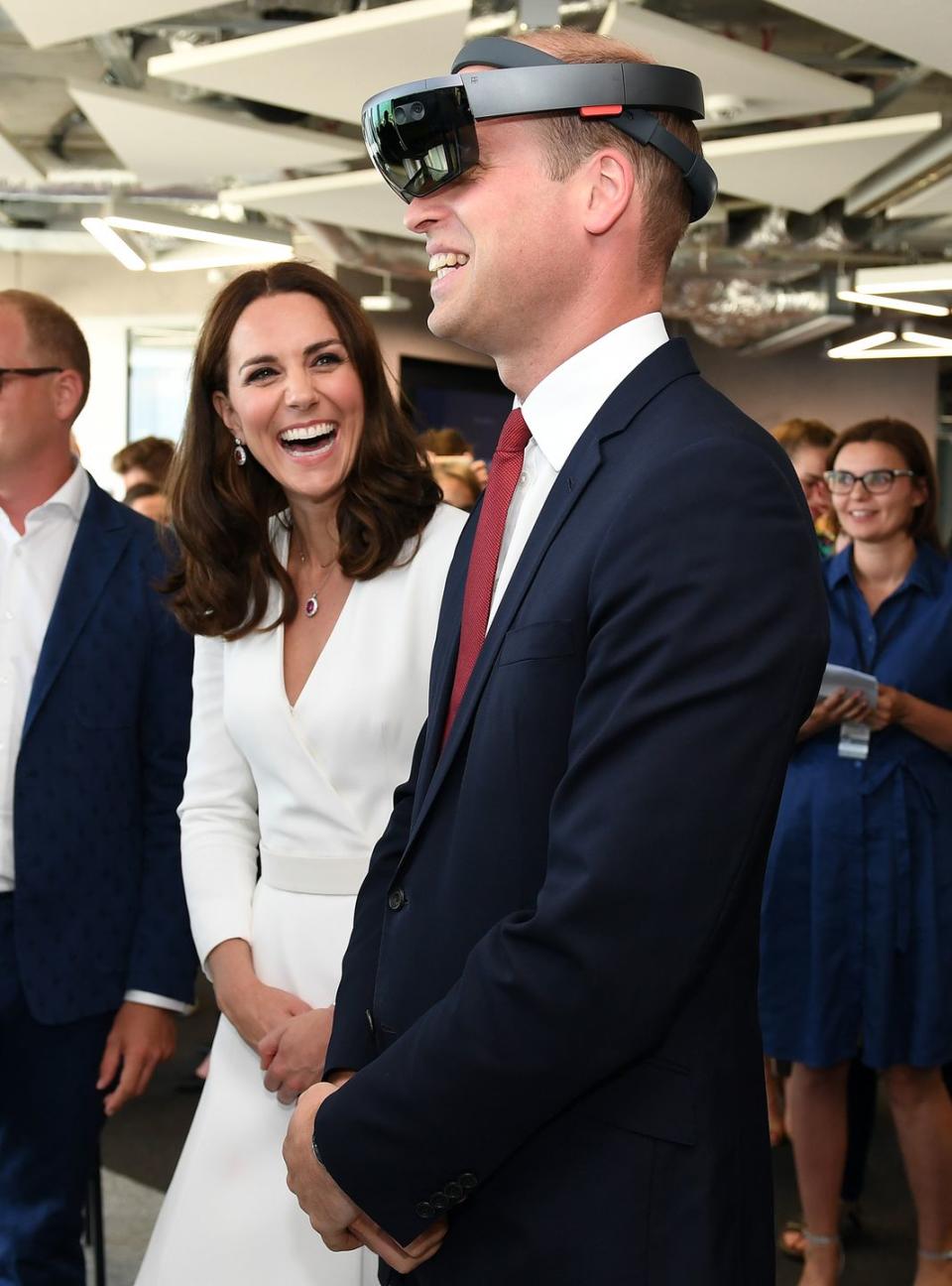 Kate can't stop laughing as Will tries on tech glasses.
