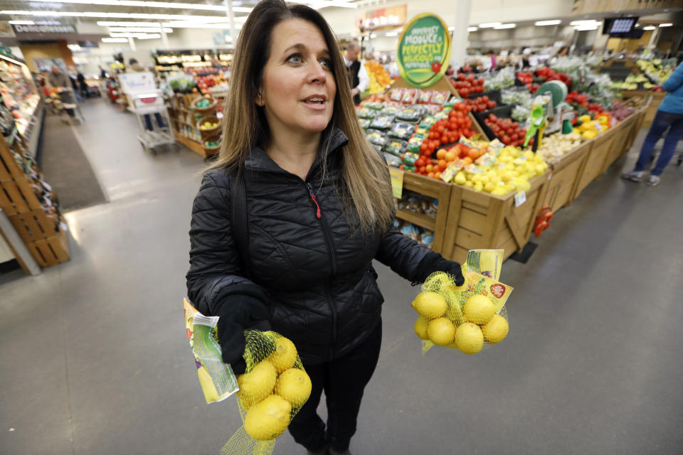 In this Friday, Jan. 18, 2019, photo, Jamie Shae, of Grimes, Iowa, talks about the lemons she found in the imperfect produce section at the Hy-Vee grocery store in Urbandale, Iowa. She didn’t realize there was anything special about the fruit. “I happened to see the bags of lemons,” said Shae, who was in a rush and grabbed two bags. (AP Photo/Charlie Neibergall)