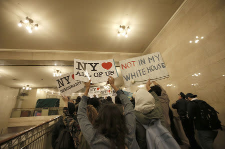 Demonstrators march through Grand Central Station while protesting against Donald Trump in midtown Manhattan in New York City, April 14, 2016. REUTERS/Mike Segar