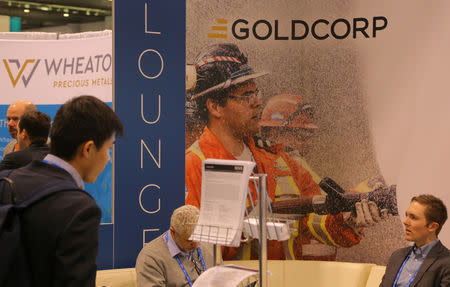 FILE PHOTO: A visitor reads a pamphlet at the Goldcorp gold mining company booth during the Prospectors and Developers Association of Canada (PDAC) annual convention in Toronto, Ontario, Canada March 4, 2019. REUTERS/Chris Helgren