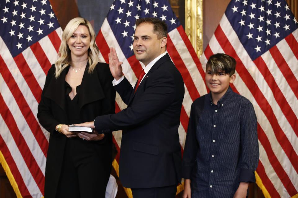 FILE - In this May 19, 2020, file photo Rep. Mike Garcia, R-Calif., center, joined by his wife Rebecca and son Preston, participates in a ceremonial swearing-in with House Speaker Nancy Pelosi of Calif., on Capitol Hill in Washington. Republicans are celebrating their recent capture of a Democratic-held House seat north of Los Angeles. They say it shows they can win suburban districts whose centrist voters fled the GOP two years ago, costing it the chamber's majority. (AP Photo/Patrick Semansky, File)