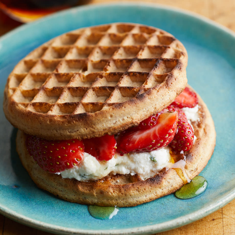 <p>Here's a sweet spin on a healthy breakfast-sandwich recipe. Other seasonal fruit, such as blueberries or sliced peaches, would be tasty toppers too.</p> <p> <a href="https://www.eatingwell.com/recipe/257798/strawberry-ricotta-waffle-sandwich/" rel="nofollow noopener" target="_blank" data-ylk="slk:View Recipe" class="link ">View Recipe</a></p>