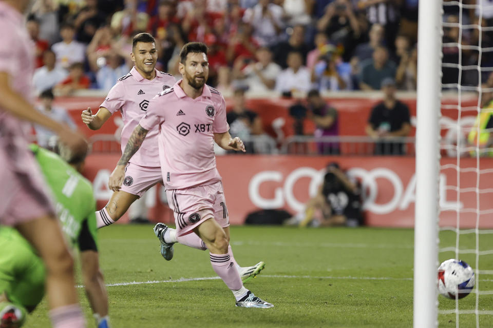 Inter Miami forward Lionel Messi, right, scores against the New York Red Bulls during an MLS soccer match at Red Bull Arena, Saturday, Aug. 26, 2023, in Harrison, N.J. (AP Photo/Eduardo Munoz Alvarez)