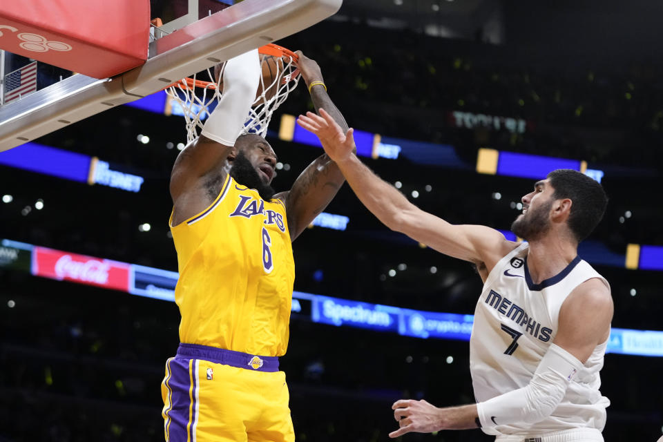 Los Angeles Lakers' LeBron James (6) dunks against Memphis Grizzlies' Santi Aldama (7) during the first half in Game 6 of a first-round NBA basketball playoff series Friday, April 28, 2023, in Los Angeles. (AP Photo/Jae C. Hong)