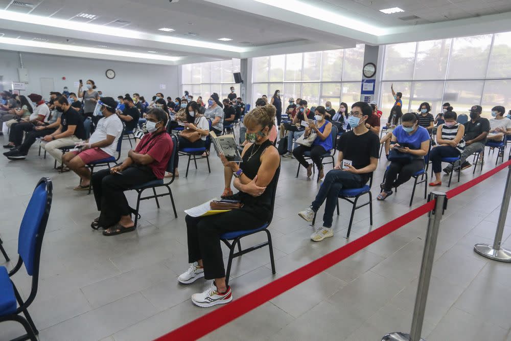 Members of the public wait to receive the AstraZeneca Covid-19 jab at Universiti Malaya, Kuala Lumpur May 5, 2021. — Picture by Yusof Mat Isa