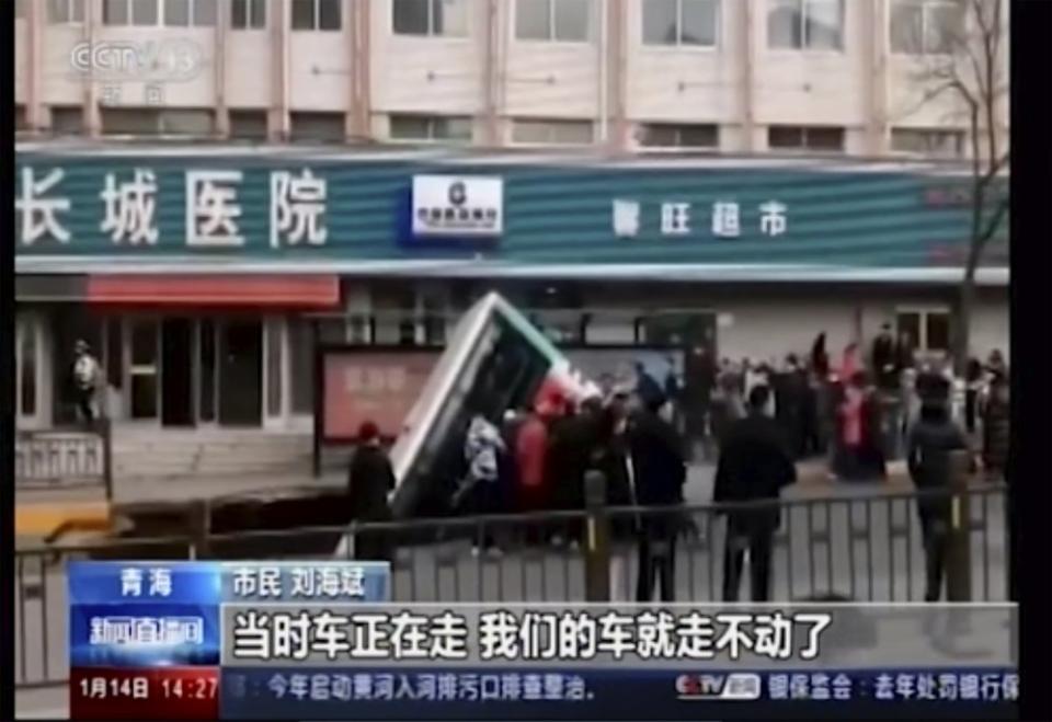 The truck plunged into a sinkhole in the centre of the a street in Xining, Qinghai province, China. Source: CCTV via AP