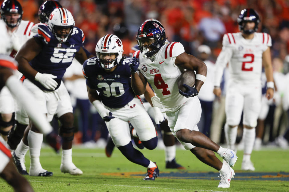 Mississippi running back Quinshon Judkins (4) carries the ball for a first down against Auburn during the first half of an NCAA college football game, Saturday, Oct. 21, 2023, in Auburn, Ala. (AP Photo/ Butch Dill )