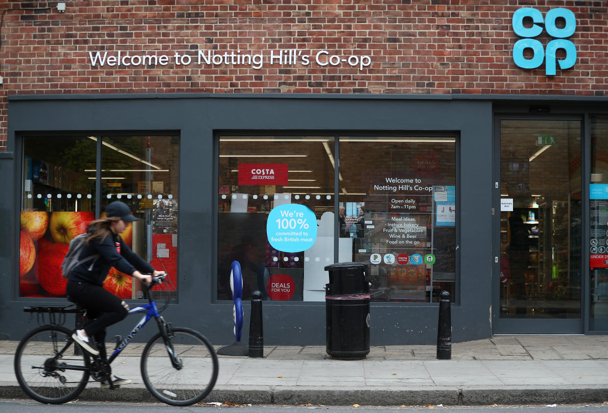 A woman cycles past a Co-op supermarket in London, Britain, September 14, 2018. REUTERS/Hannah McKay