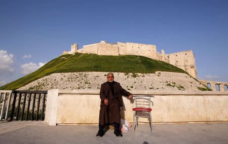 A man sits near Aleppo's ancient citadel, in the old city of Aleppo, Syria April 9, 2019. Picture taken April 9, 2019. REUTERS/Omar Sanadiki