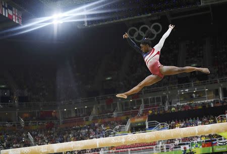 Simone Biles competes on the beam during the women's team final. REUTERS/Dylan Martinez