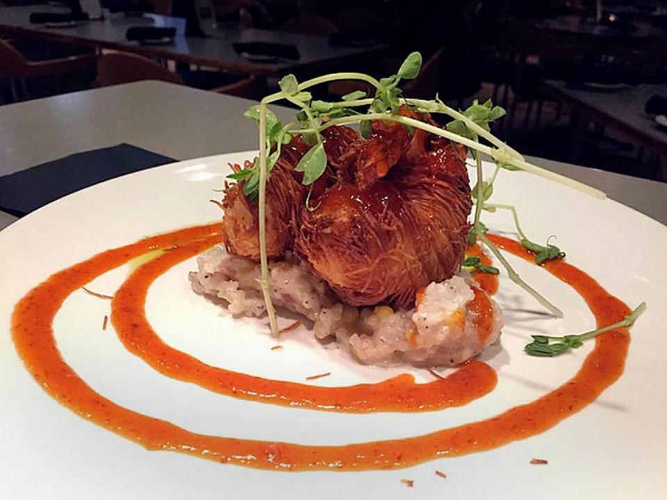 Azur’s signature woven shrimp are served over coconut sweet corn risotto with a honey, garlic and red chili glaze.