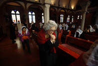 A woman prays during a mass at a catholic church in Seoul February 12, 2013. Pope Benedict left the Catholic world in shock after becoming the first pontiff since the Middle Ages to resign his office, saying that failing strength had left him unable to lead the church through a period of relentless change and turmoil. REUTERS/Kim Hong-Ji (SOUTH KOREA - Tags: RELIGION) - RTR3DNXU