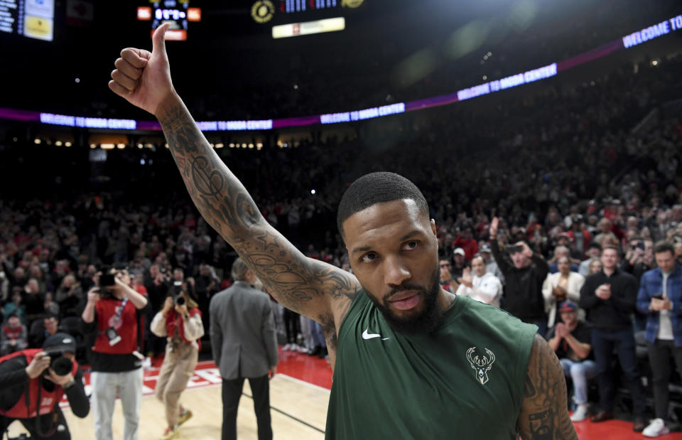 Milwaukee Bucks guard Damian Lillard acknowledges the crowd as he is introduced before an NBA basketball game against the Portland Trail Blazers in Portland, Ore., Wednesday, Jan. 31, 2024. (AP Photo/Steve Dykes)