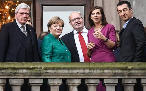 German Chancellor Angela Merkel (C) Volker Bouffier (L), Minister President of Hesse, The Federal Green Party Chairman, Cem Ozdemir (R) on the first day of coalition talks in October - Credit: FILIP SINGER/EPA