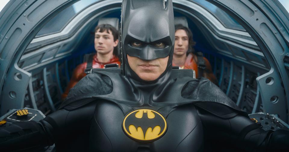 Batman (Michael Keaton, center) is coaxed out of retirement by two versions of Barry Allen (Ezra Miller) in "The Flash."