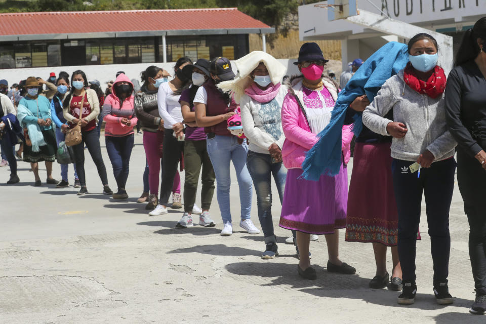 Voters line up during general elections in Cangahua, Ecuador, Sunday, Feb. 7, 2021. Amidst the new coronavirus pandemic Ecuadoreans went to the polls in a first round presidential and legislative election. (AP Photo/Dolores Ochoa)