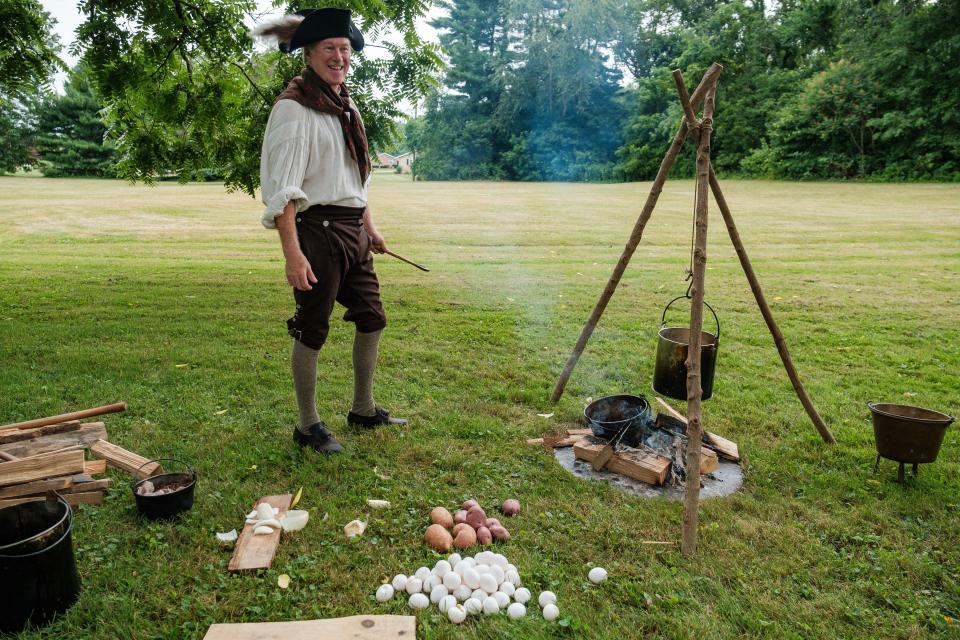 Mark Gaynor, of Zoar, portrays a mess cook during annual  Revolutionary War reenactments, Saturday, July 15 at Fort Laurens in Lawrence Township. Gaynor was cooking bacon, scrambled eggs, and potatoes, as well as brewing coffee. Cooking vessels were typically made of tin, and eventually sheet metal as the British withheld tin supply from Cornwall, England.