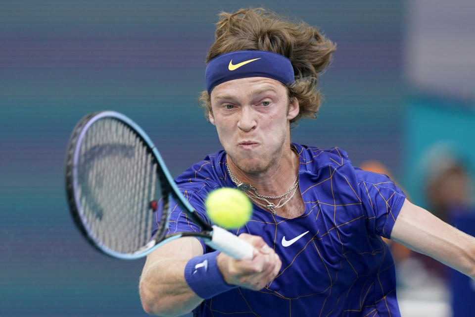 Andrey Rublev, of Russia, returns a shot from Nick Kyrgios, of Australia, during the Miami Open tennis tournament, Friday, March 25, 2022, in Miami Gardens, Fla. (AP Photo/Wilfredo Lee)