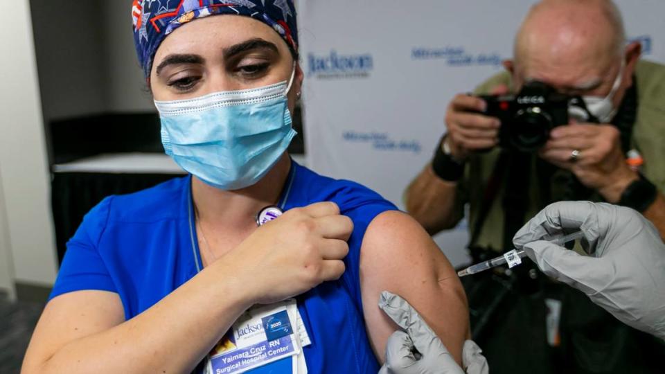 COVID-unit nurse Yaimara Cruz receives the Pfizer BioNTech vaccine at Jackson Memorial Hospital in Miami on Dec. 15.