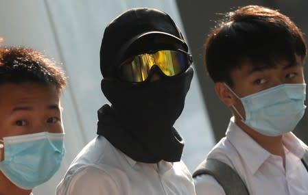 Secondary school students wearing masks join a human chain protesting against what they say is police brutality against protesters, after clashes at Wan Chai district in Hong Kong