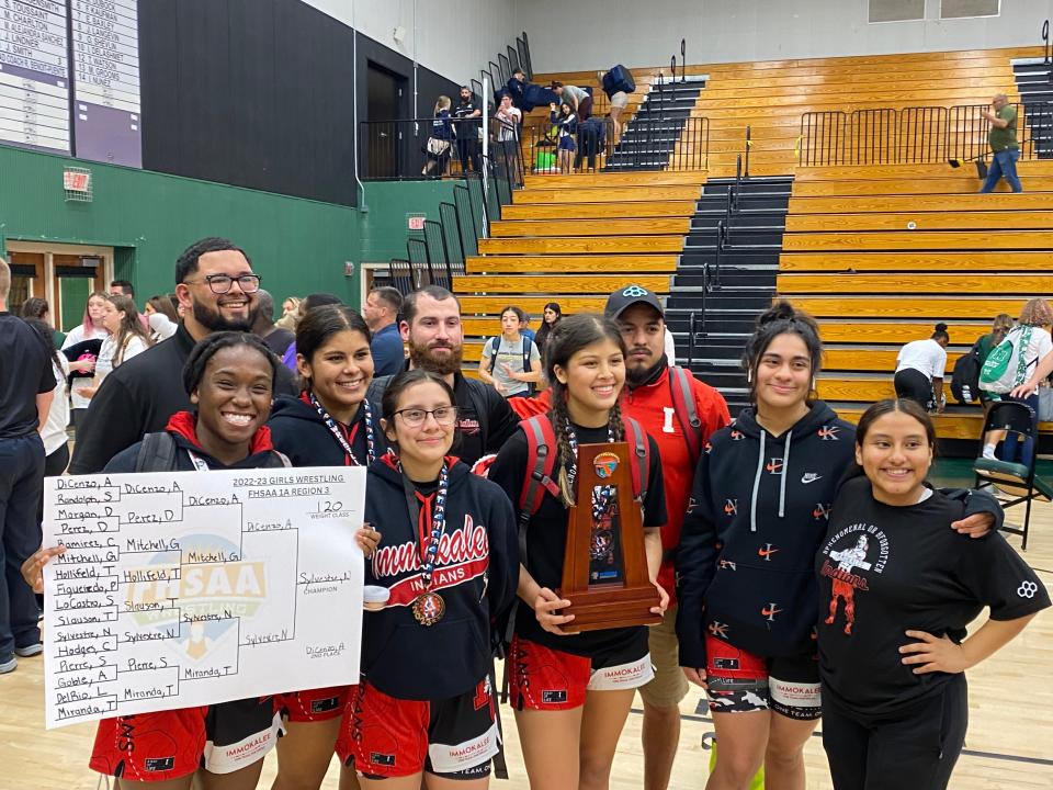 The Immokalee girls wrestling team pose after winning the Class 1A-Region 3 team title on February 18, 2023.