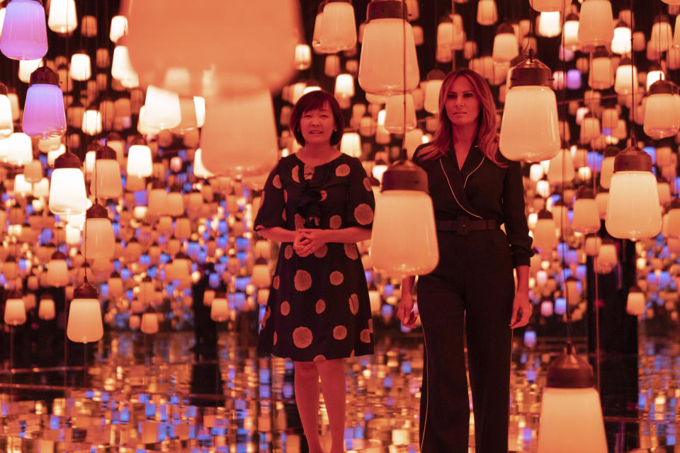 U.S. first lady Melania Trump, right, and Japanese Prime Minister Shinzo Abe's wife Akie Abe visit a digital art museum in Tokyo Sunday, May 26, 2019. (Pierre-Emmanuel Deletree/Pool Photo via AP)