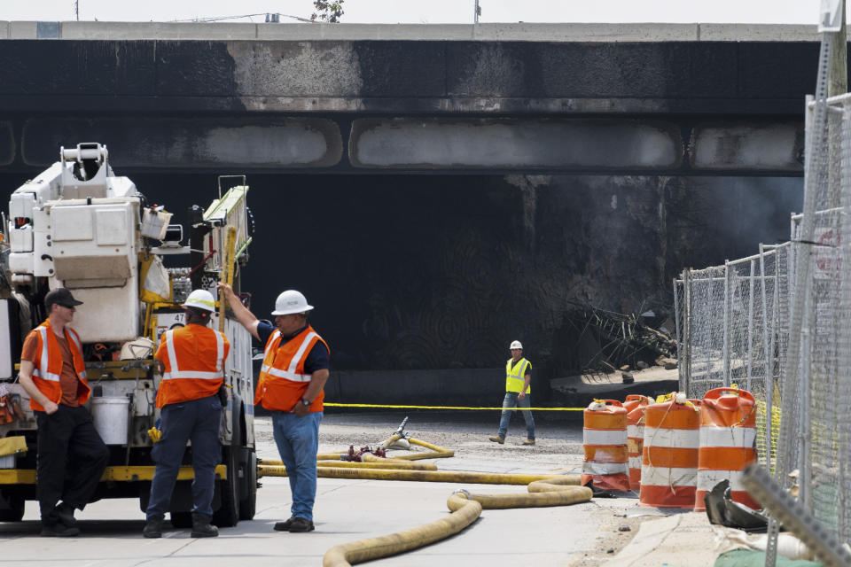 Officials work on the scene following the collapse of an elevated section of Interstate 95 after a tanker truck caught fire, Sunday, June 11, 2023, in Philadelphia. (AP Photo/Joe Lamberti)