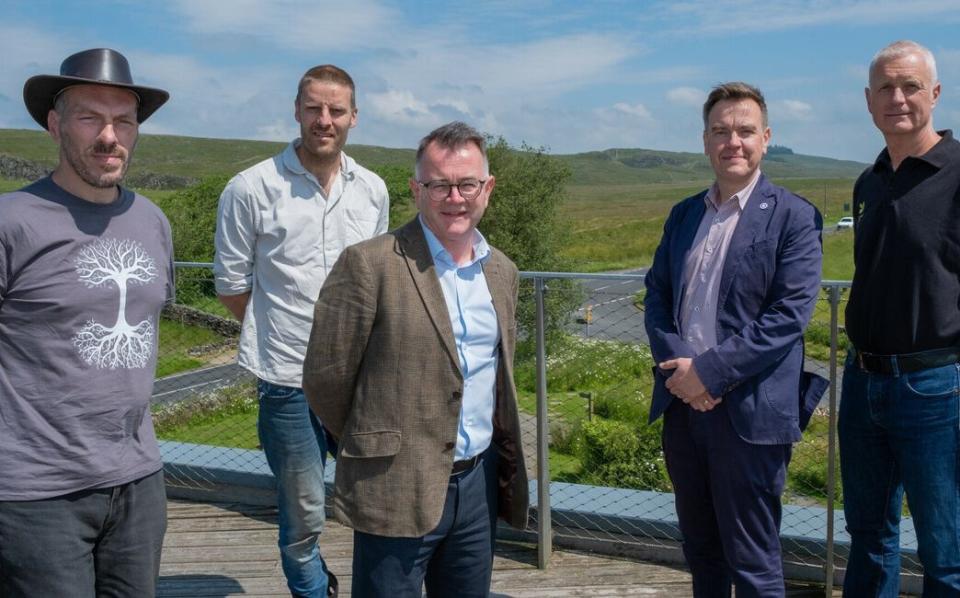 Nick Greenall, Charlie Whinney, Tony Gates, Rob Wiliamson and Andy Poad on the roof of The Sill centre with Sycamore Gap in the background