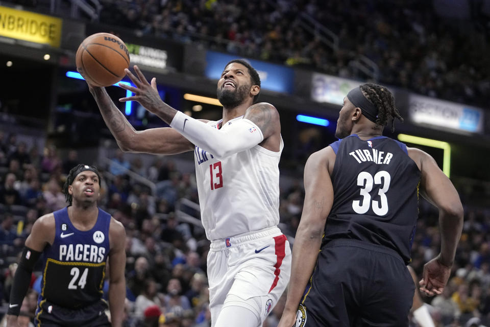 LA Clippers' Paul George (13) puts up a shot over Indiana Pacers' Myles Turner (33) during the second half of an NBA basketball game, Saturday, Dec. 31, 2022, in Indianapolis. (AP Photo/Darron Cummings)