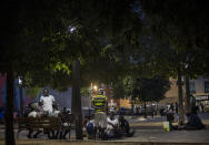 Migrants who are seeking seasonal work harvesting fruit, stand in a square in Lleida, Spain, Thursday, July 2, 2020. Authorities in northeast Spain have ordered the lockdown of a county around the city of Lleida due to worrying outbreaks of the COVID-19 virus. Catalan regional authorities announced Saturday, July 4, 2020 that as of noon local time movement will be restricted to and from the county of El Segriá around Lleida which is home to over 200,000 people. Residents will have until 4 p.m. to enter the area. The new outbreaks are linked to agricultural workers in the rural area. (AP Photo/Emilio Morenatti)