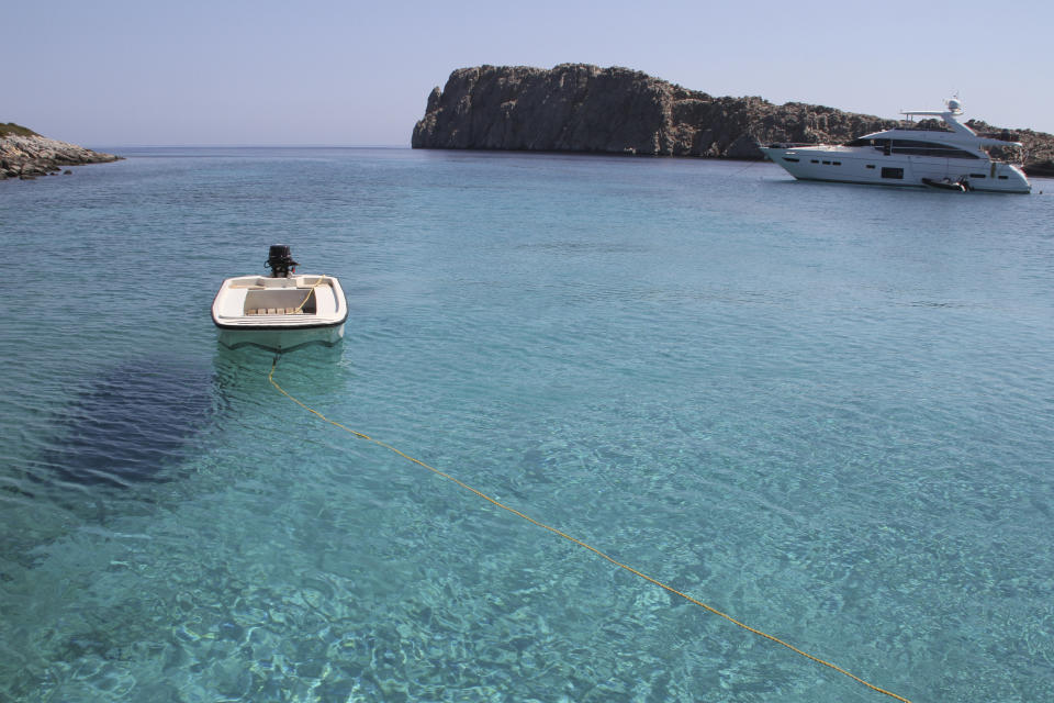 FILE - The multihued waters of the Aegean Sea sparkle by the islet of Kounoupa off the island of Astypalea, Greece, on Aug. 30, 2021. Greece aims to create two large marine parks as part of a 780 million euro program to protect biodiversity and marine ecosystems, with the plans to be formally announced at an international oceans conference starting in Athens Tuesday. (AP Photo/Giovanna Dell'Orto, File)