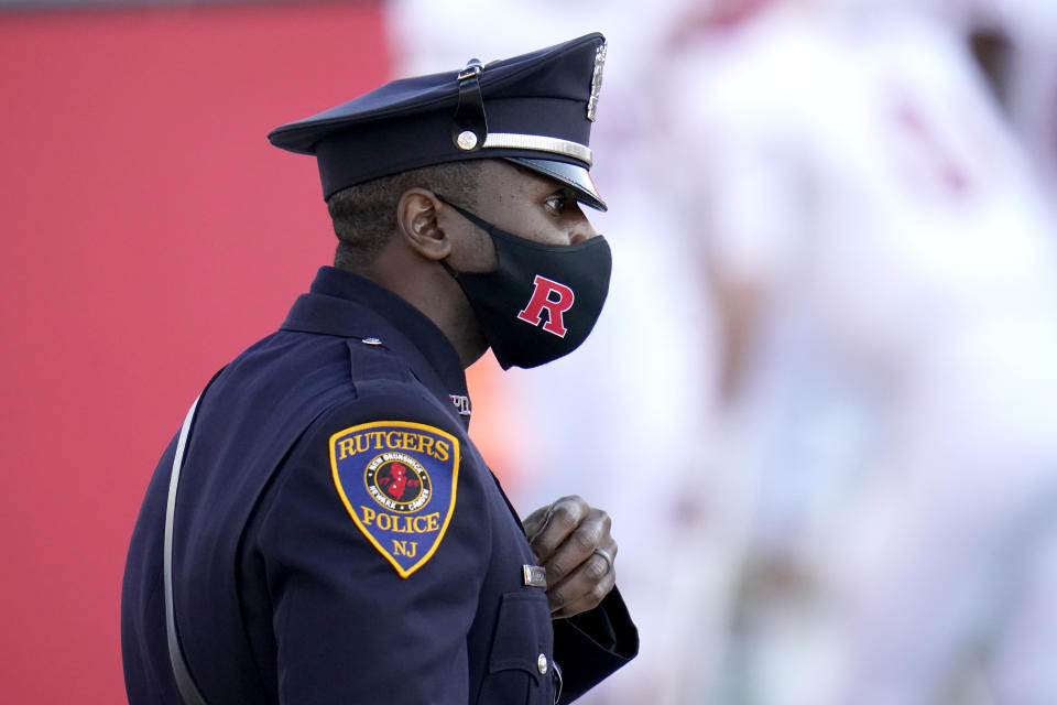 A Rutgers Police Department officer wears a face mask to protect against COVID-19 during the second half of an NCAA college football game between Maryland and Rutgers, Saturday, Dec. 12, 2020, in College Park, Md. Rutgers won 27-24 in overtime. (AP Photo/Julio Cortez)