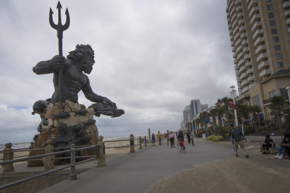 Visitors walk the boardwalk of the Virginia Beach Oceanfront during Tropical Storm Ophelia on Saturday, Sept. 23, 2023, in Virginia Beach, Va. (AP Photo/John C. Clark)