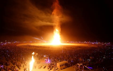 The Man is engulfed in flames as approximately 70,000 people from all over the world gathered for Burning Man  - Credit: Reuters