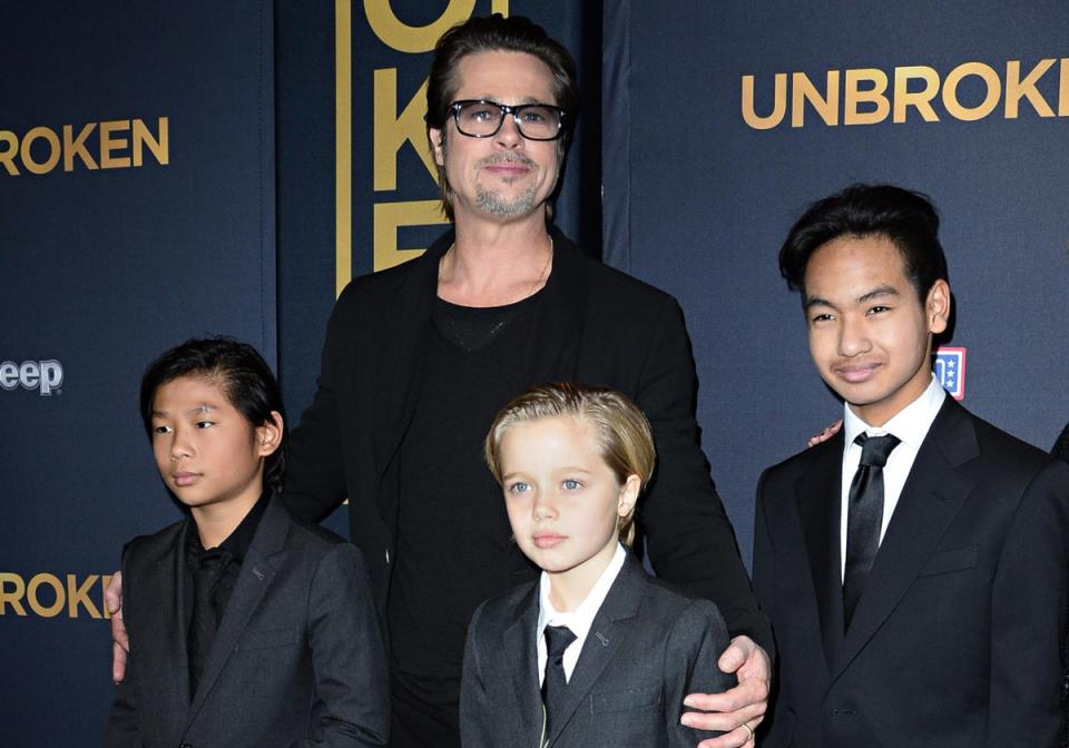 Actor Brad Pitt and children Pax Jolie-Pitt (L), Shiloh Jolie-Pitt (C) and Maddox Jolie-Pitt, pictured at a film premiere in Hollywood in 2014 (ROBYN BECK/AFP/Getty Images)