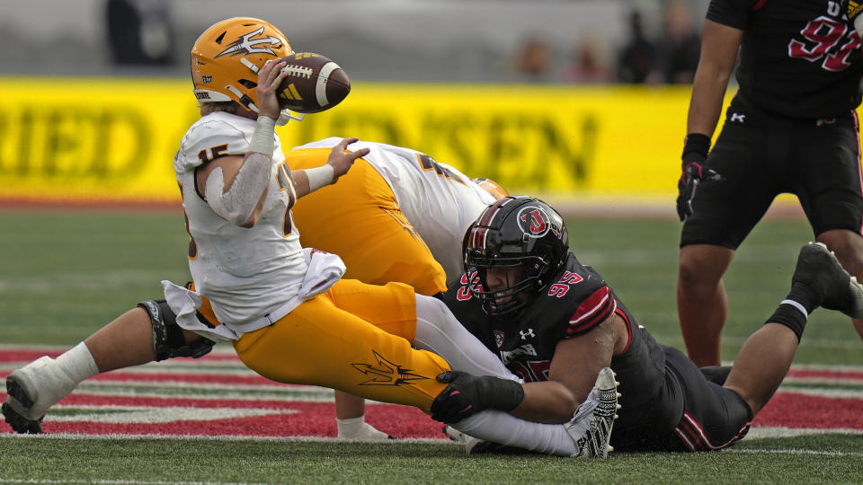 Utah defensive tackle Aliki Vimahi (95) sacks Arizona State quarterback Jacob Conover (15) during the second half of an NCAA college football game Saturday, Nov. 4, 2023, in Salt Lake City. (AP Photo/Rick Bowmer)