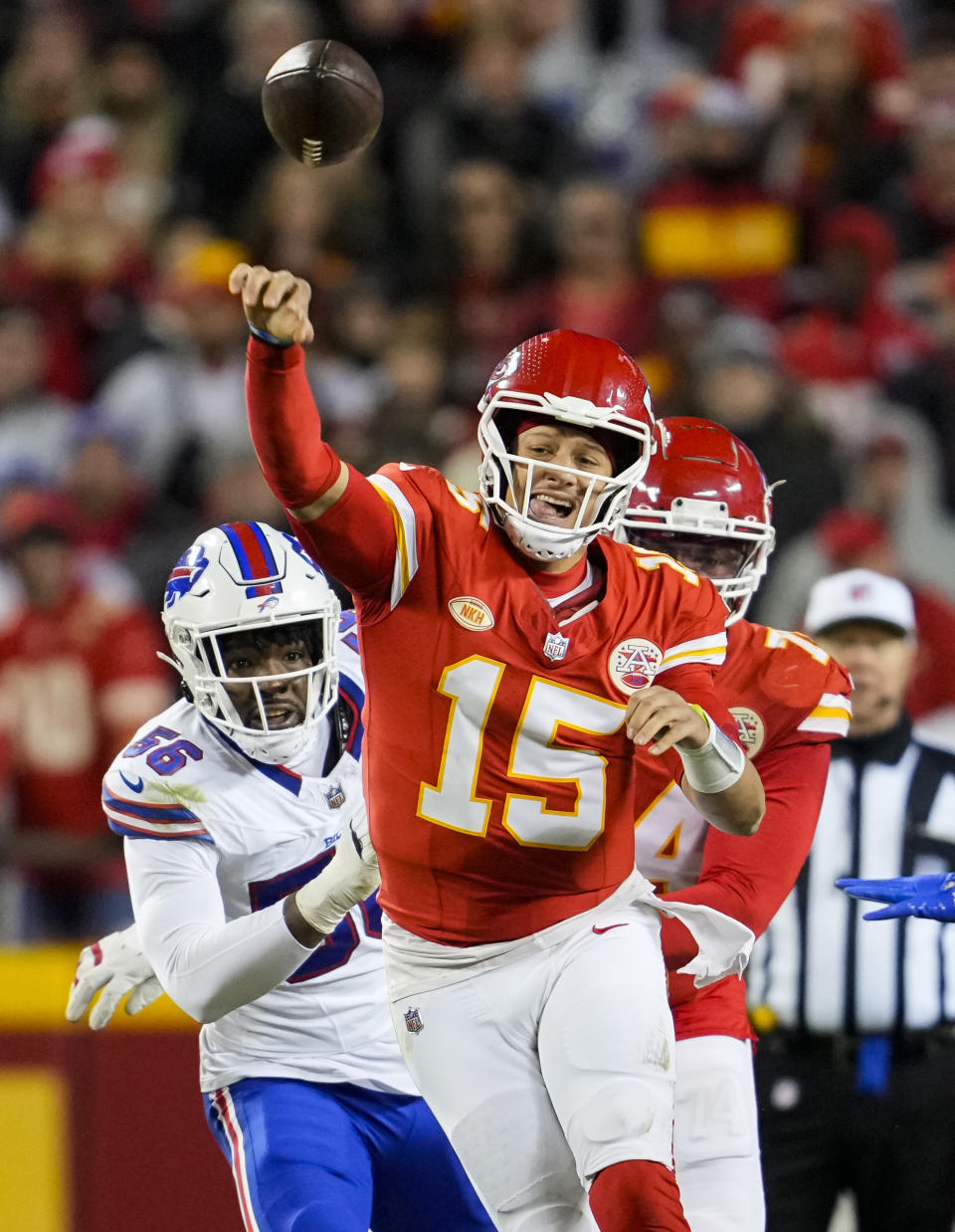 Dec 10, 2023; Kansas City, Missouri, USA; Kansas City Chiefs quarterback Patrick Mahomes (15) throws a pass as Buffalo Bills defensive end Leonard Floyd (56) defends during the second half at GEHA Field at Arrowhead Stadium. Mandatory Credit: Jay Biggerstaff-USA TODAY Sports