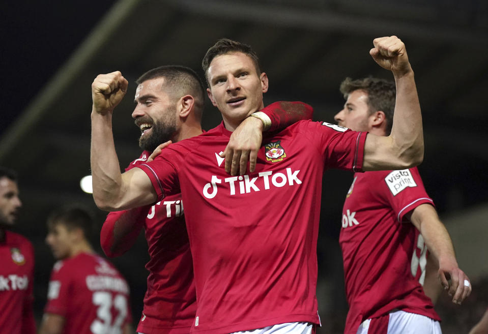 Wrexham's Paul Mullin celebrates scoring against Sheffield United during the English FA Cup fourth round soccer match at The Racecourse Ground, Wrexham, Wales, Sunday Jan. 29, 2023. (Peter Byrne/PA via AP)