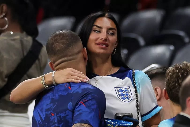 Kyle Walker embraces wife annie kilner at side of pitch