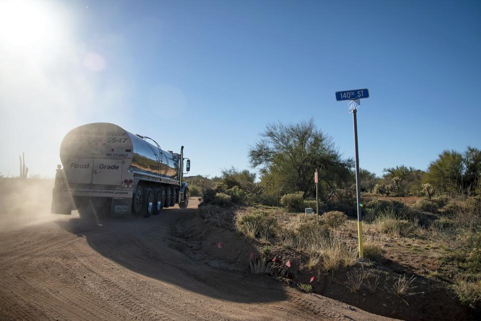 A Rio Verde Potable Water truck drives down a dirt road in Rio Verde Foothills on Feb. 12, 2022.