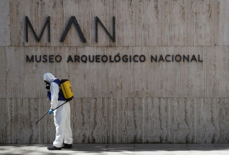 A member of the Spanish Emergency Military Unit (UME) wearing a full personal protective equipment disinfects outside the Archaeological Museum in Madrid