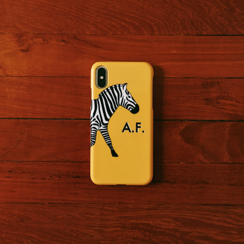 custom yellow zebra phone case on iphone x on wooden surface
