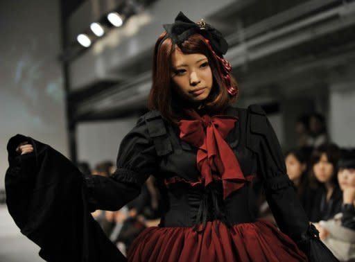 A model display creations by Vantan Design Institute students at a fashion show on October 22. Lolita models were big hits at this autumn's Japan Fashion Week, showing off puff sleeves with tiny top hats and huge ribbons