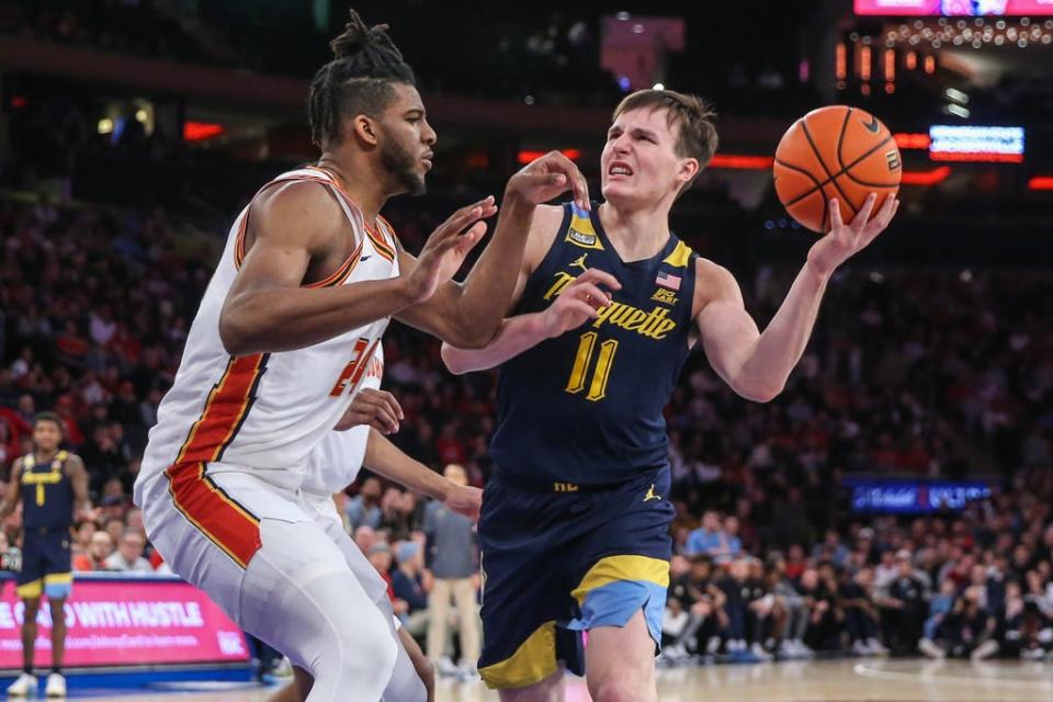 Marquette guard Tyler Kolek looks to drive past St. John's forward Zuby Ejiofor in the first half on Saturday at Madison Square Garden.