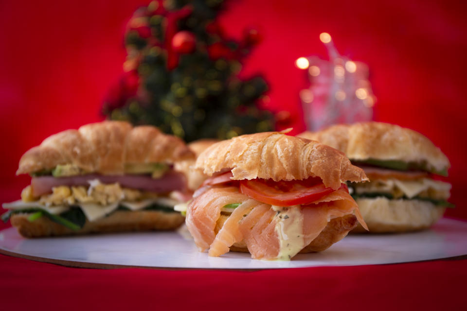 croissant sandwich of a salmon, ham and avocado