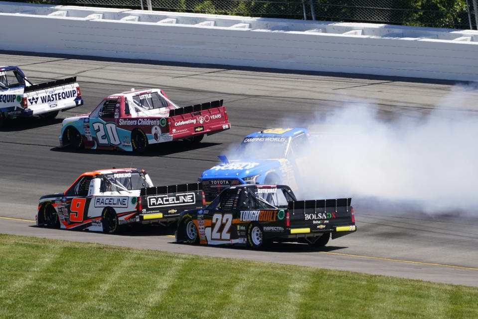 Todd Bodine (62) slides down the back section beside Blaine Perkins (9) and Max Gutierrez (22) during the NASCAR Truck Series Race at Pocono Raceway, Saturday, July 23, 2022 in Long Pond, Pa. (AP Photo/Matt Slocum)