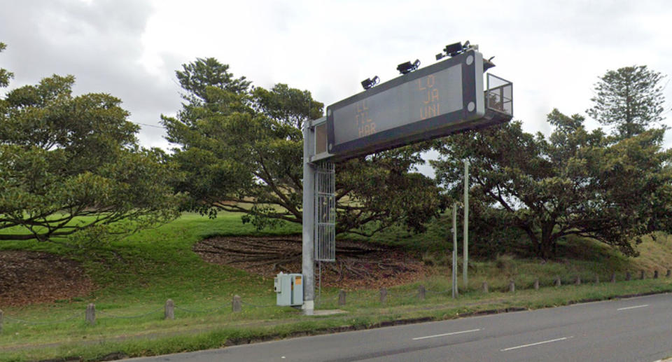 Mobile phone detection cameras above a sign in NSW.